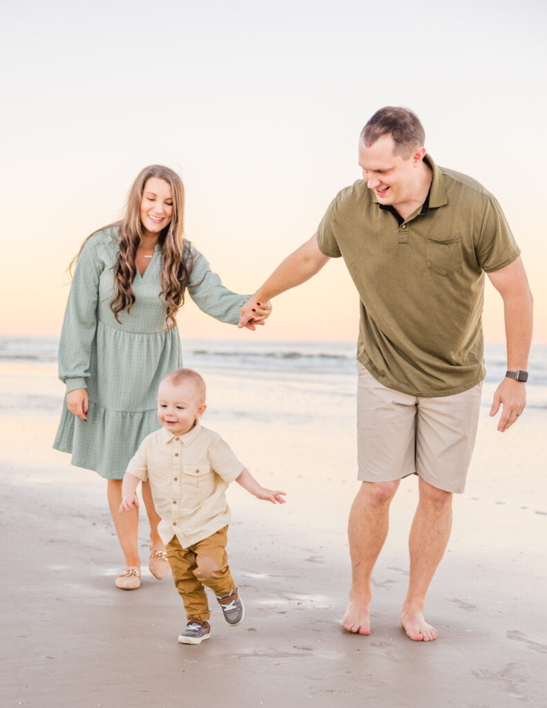 Children running along the shoreline during a New Smyrna Beach family session