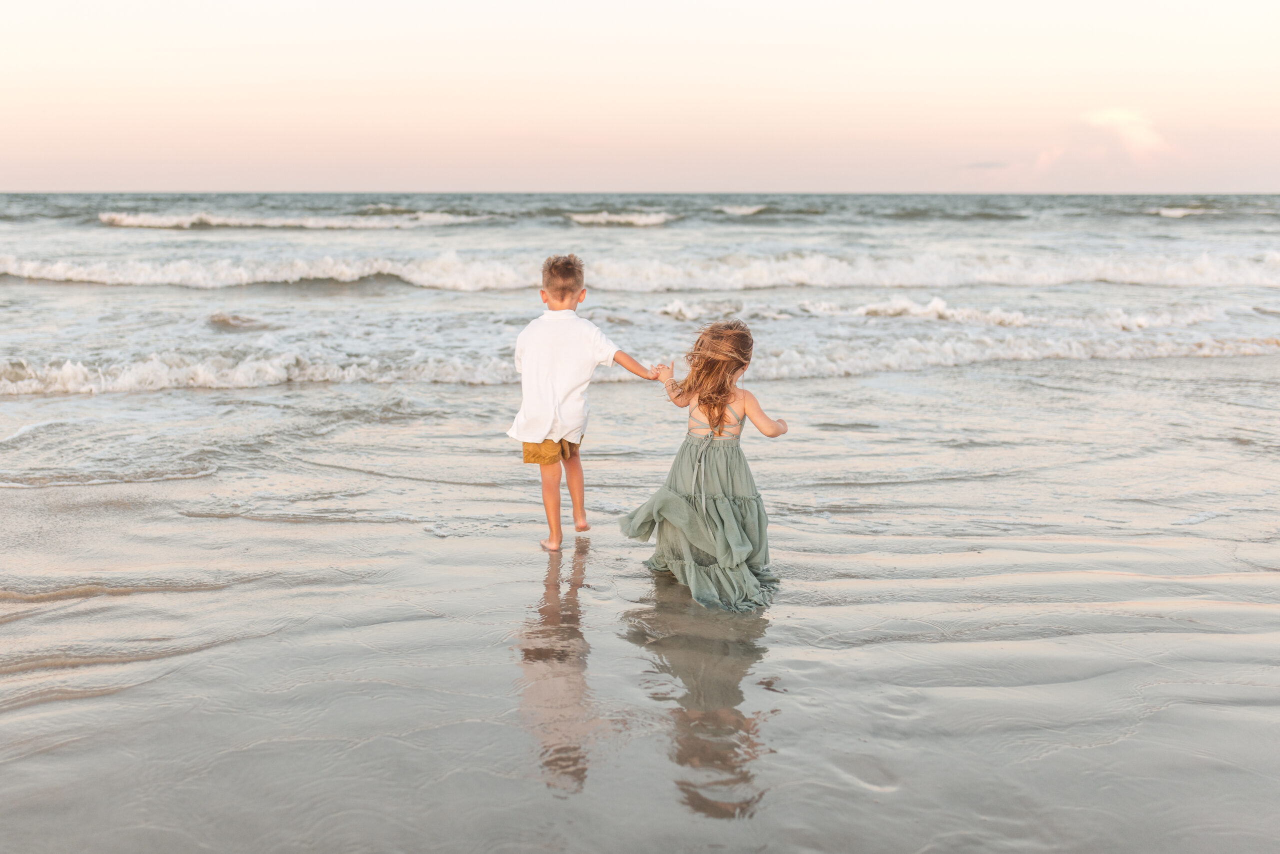 St. Augustine Family Photographer | Timeless Memories on Florida’s Historic Coast 6 Children laughing and playing in the waves at Vilano Beach during sunrise