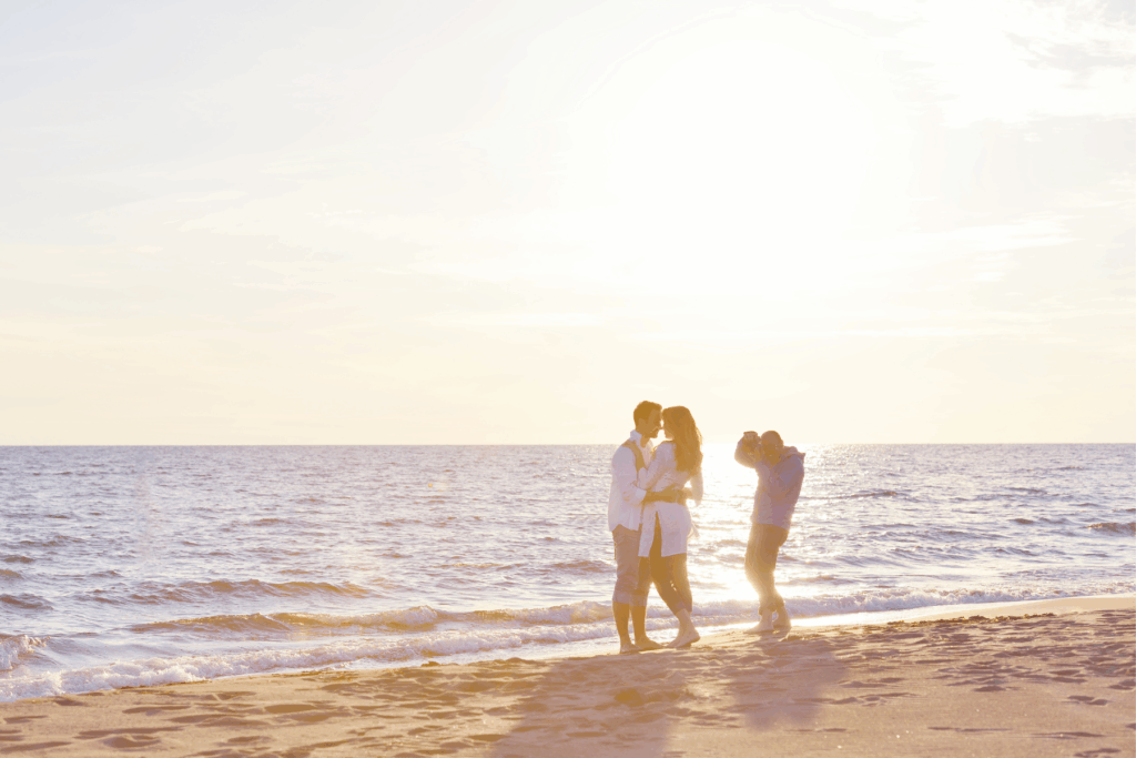 Photographer capturing family session at sunrise on Florida coast